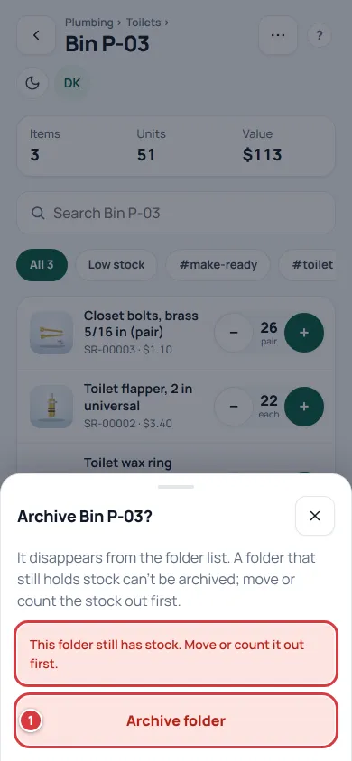 The Archive sheet after it refused: the red message says the folder still has stock.